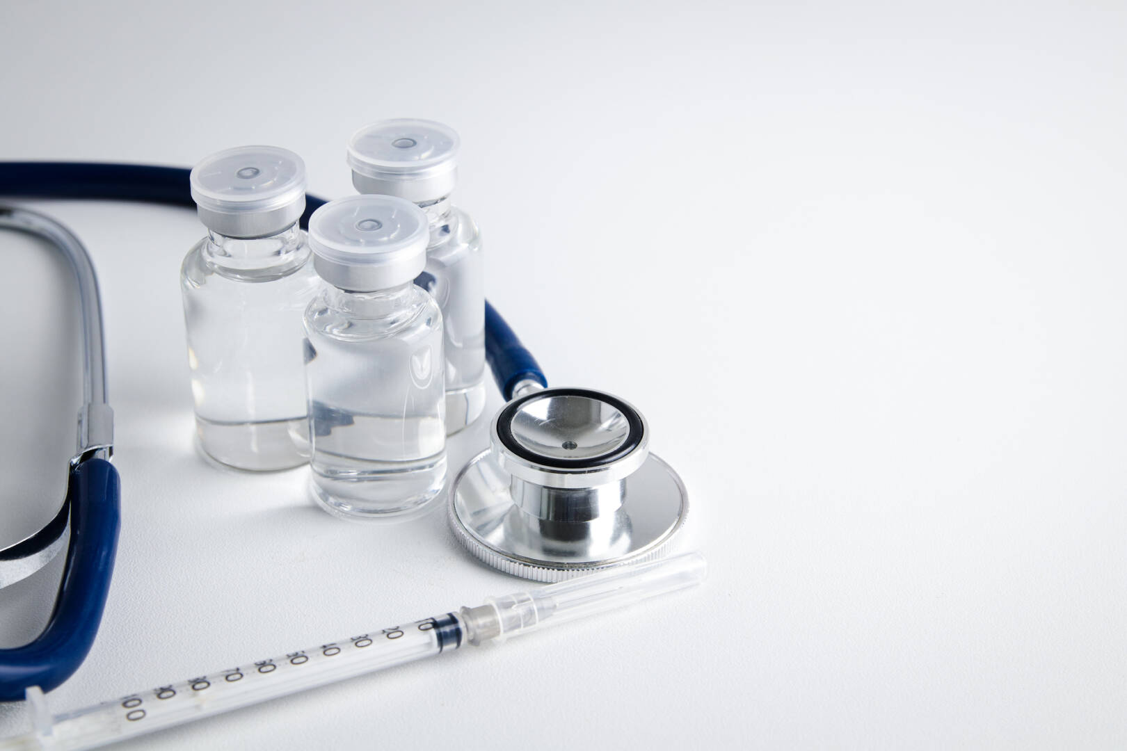medium-vecteezy_anti-virus-vaccine-bottle-with-syringe-and-stethoscope_11834217_medium