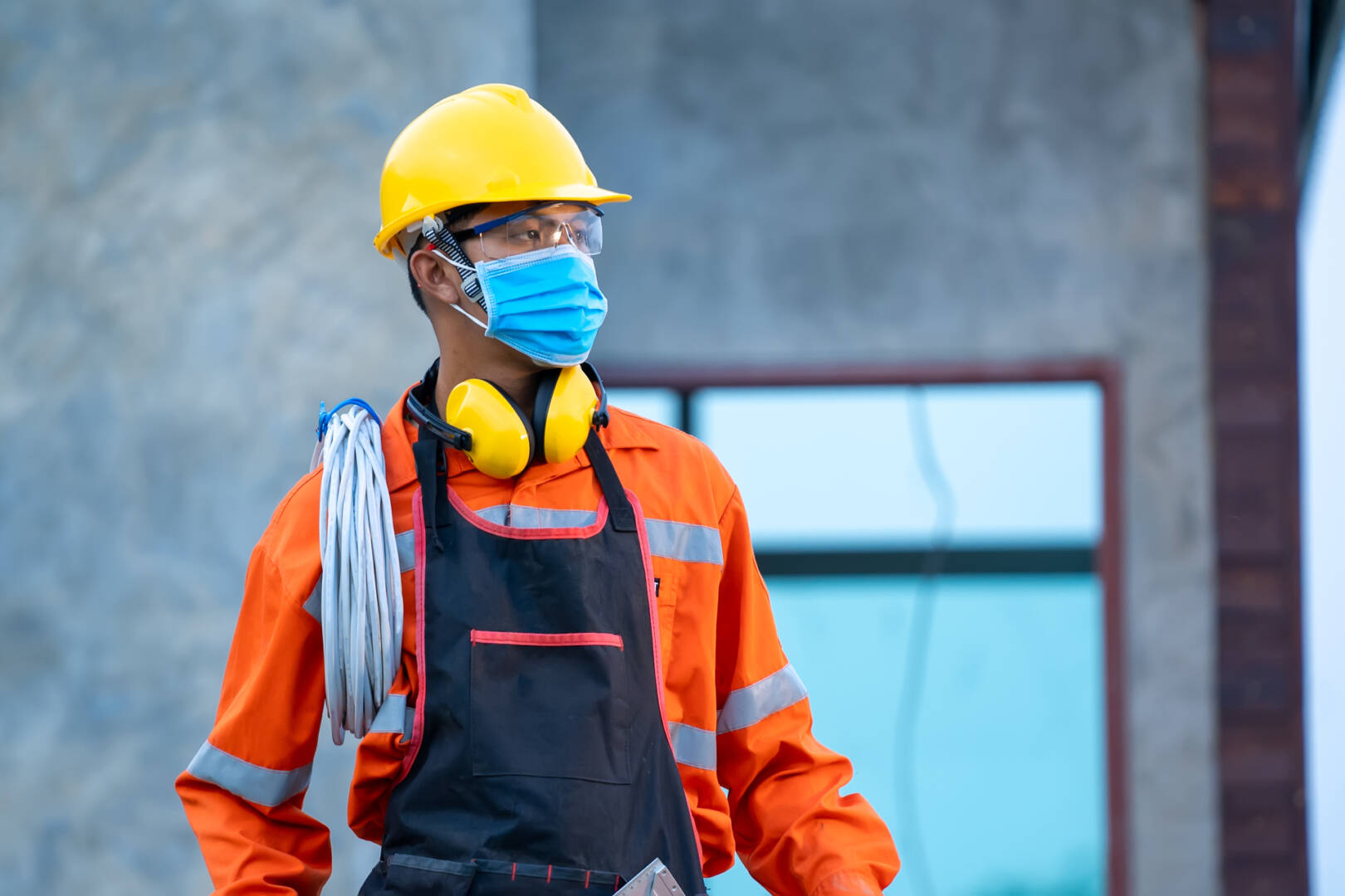 Electrician wearing protective mask to Protect Against Covid-19