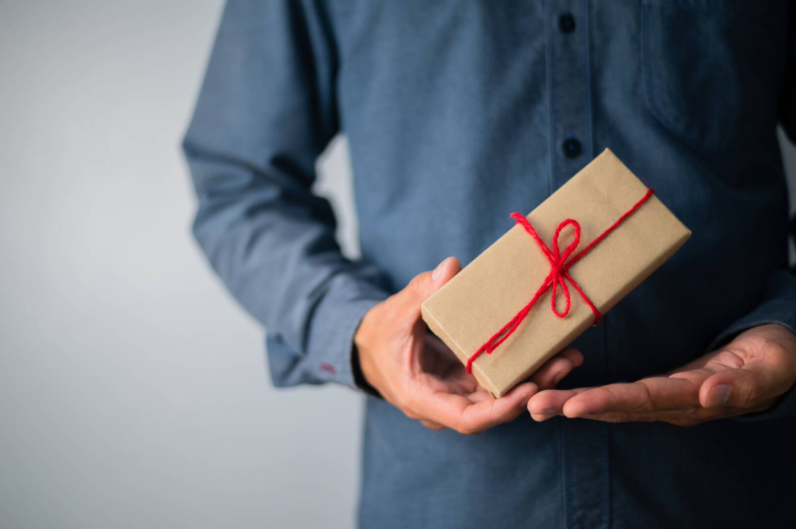 medium-vecteezy_hand-holding-gift-box-new-year-gift-box-christmas-gift-box_3548102_medium